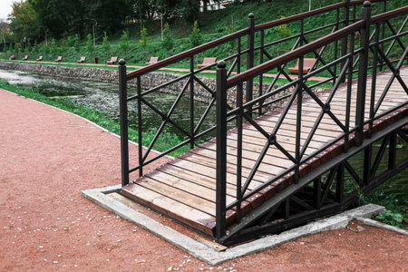View of beautiful bridge across lake in parkの写真素材