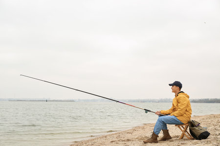 Teenage boy fishing on riverの写真素材