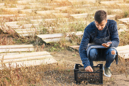 Worker taking care of snails at the farmの写真素材