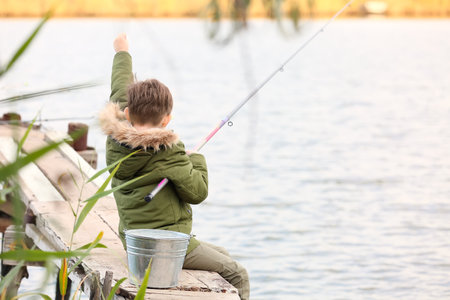 Little boy fishing on the riverの写真素材