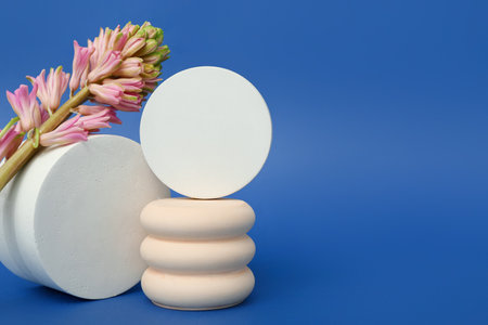 Podiums with beautiful flowers on blue background. hello springの写真素材