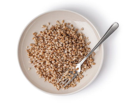 Plate of tasty buckwheat porridge isolated on white backgroundの写真素材