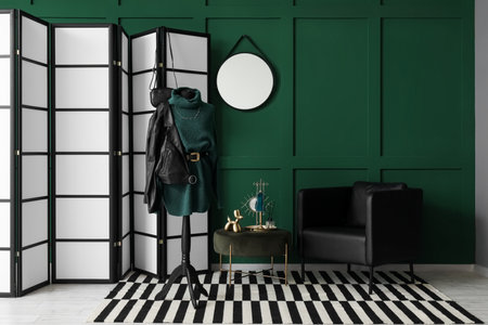 Interior of fashion designer's studio with mannequin, clothes and folding screenの写真素材
