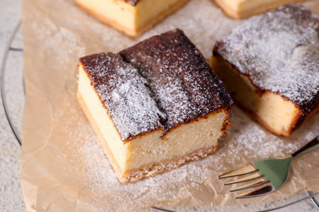 Grid with pieces of cottage cheese casserole on table, closeupの写真素材