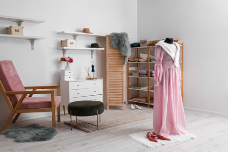Interior of fashion designer's studio with mannequin, clothes and armchairの写真素材