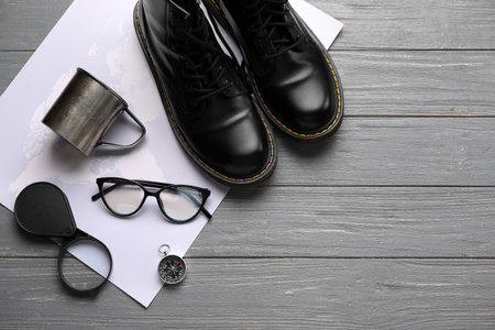 Compass with travel accessories on gray wooden backgroundの写真素材