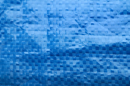Texture of blue checkered fiber as background, closeup