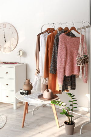 Rack with clothes in interior of modern roomの写真素材