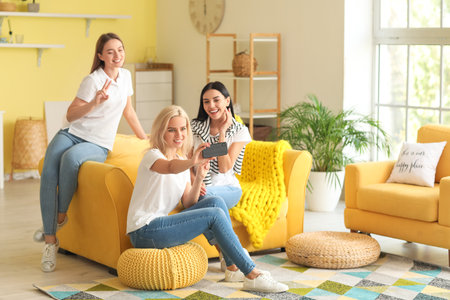Beautiful young women taking selfie at home