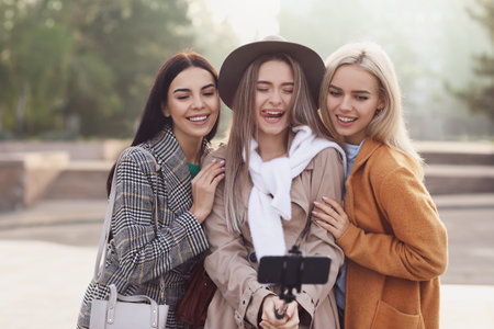 Beautiful young women taking selfie outdoorsの写真素材