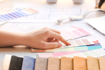 Female interior designer with color palettes in office, closeupの写真素材