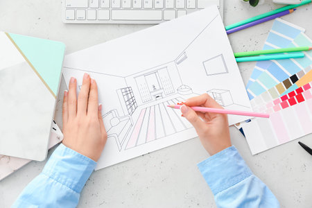 Female interior designer drawing house plan in officeの写真素材