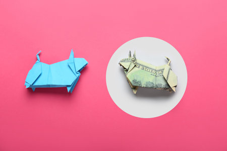 Origami bulls as symbol of year 2021 on color backgroundの写真素材