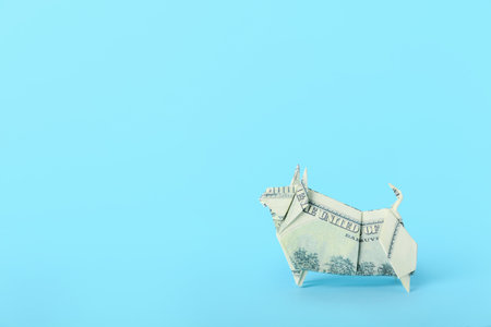 Origami bull as symbol of year 2021 on color backgroundの写真素材