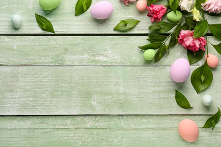 Composition with plant branches, eustoma flowers and painted Easter eggs on color wooden background