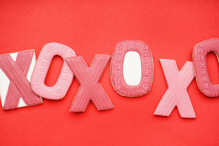 Sweet cookies for Valentine's Day celebration on red backgroundの写真素材