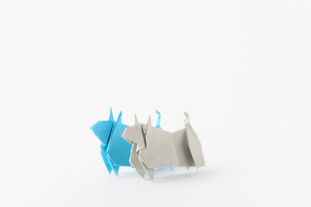 Origami bulls as symbol of year 2021 on white backgroundの写真素材