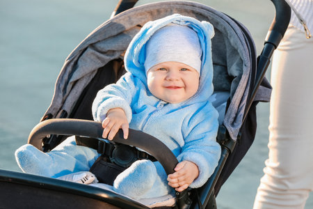 Cute funny baby in stroller outdoors