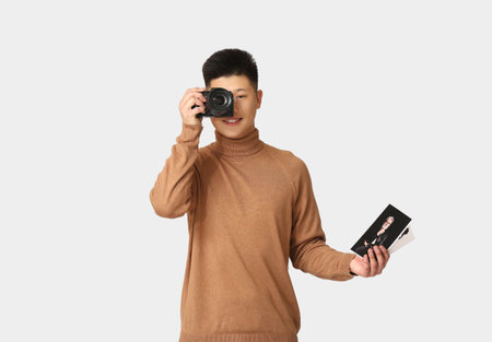 Male Asian photographer on white background