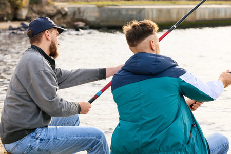 Young men fishing on the river