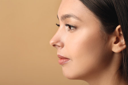 Beautiful young woman with fake eyelashes against color backgroundの写真素材