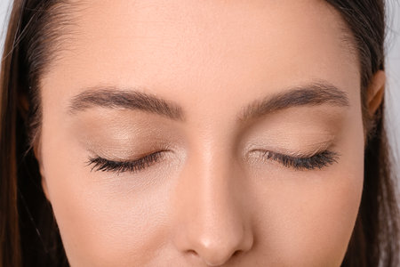 Beautiful young woman with eyelash extensions, closeup