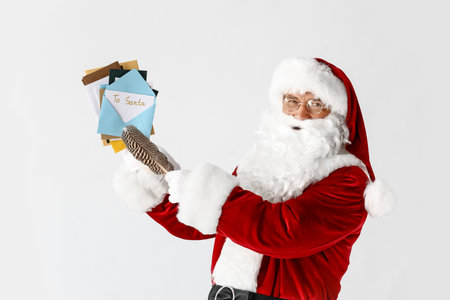 Santa Claus with letters on light backgroundの写真素材