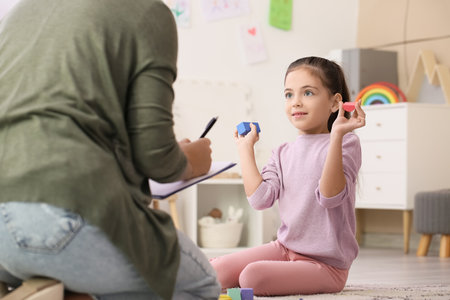 Little girl during psychotherapy session at homeの写真素材