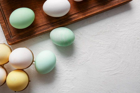 Holder with Easter eggs on light backgroundの写真素材
