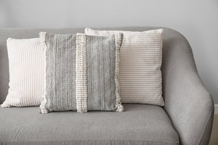 Soft pillows on gray sofa in living room