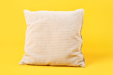 Soft pillow on yellow backgroundの写真素材