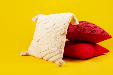 Decorative pillows on yellow backgroundの写真素材