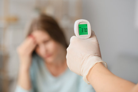 Measuring of woman's temperature in office. Coronavirus epidemic