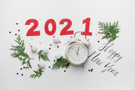 New Year composition with alarm clock and figure 2021 on white backgroundの写真素材
