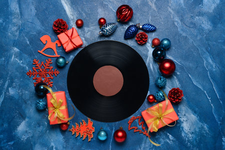 Vinyl disk and Christmas decor on color backgroundの写真素材