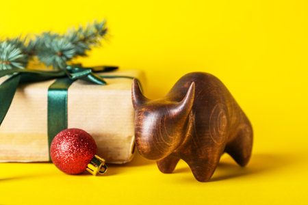 Figurine of bull and New Year gift on color backgroundの写真素材