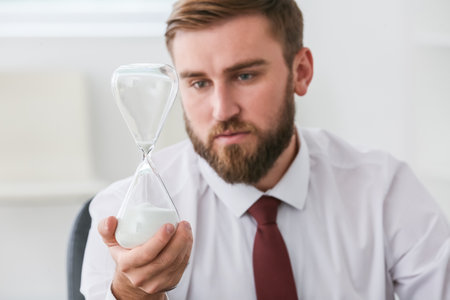 Businessman with hourglass in office