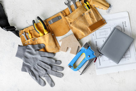 Figure of house and construction tools on light backgroundの写真素材