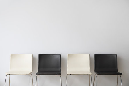 modern chairs near light wall