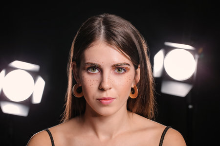 Beautiful woman with unusual makeup on dark background