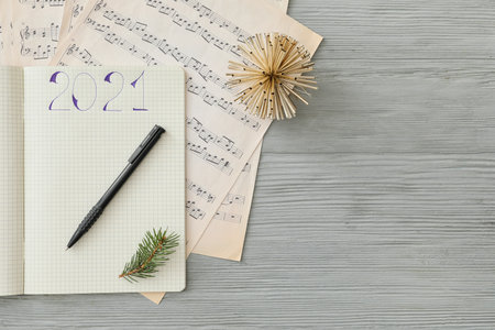 New Year composition with notebook and note sheets on tableの写真素材