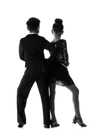 Silhouette of little children dancing against white backgroundの写真素材