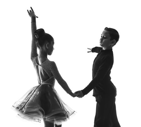 Silhouette of little children dancing against white backgroundの写真素材