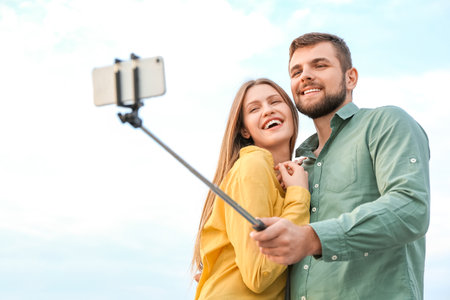 Young couple taking selfie outdoorsの写真素材