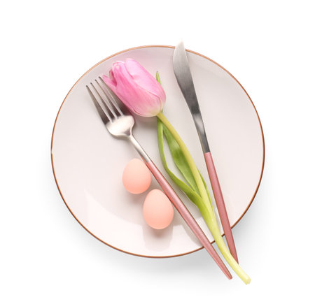 Table setting with Easter eggs, cutlery and tulip flower isolated on white background