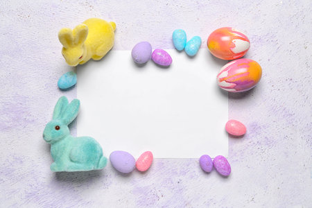 Composition with blank card, Easter eggs and bunnies on light backgroundの写真素材
