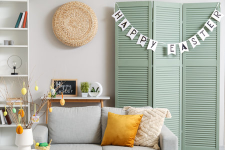 Interior of living room decorated for Easter celebration with sofa and folding screen