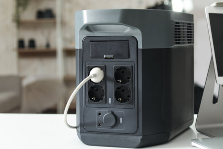 Portable power station on table in photo studio, closeup