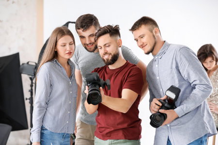Mentor teaching young photographers in studioの写真素材