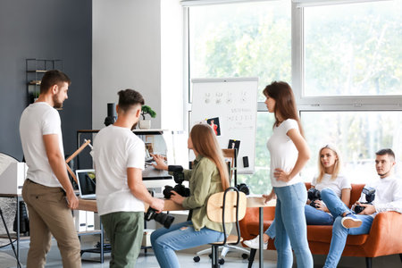 Mentor teaching young photographers in studio
